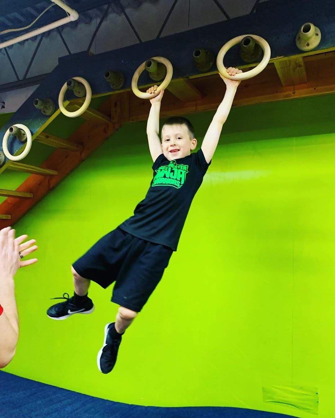 Child swinging on Ninja rings